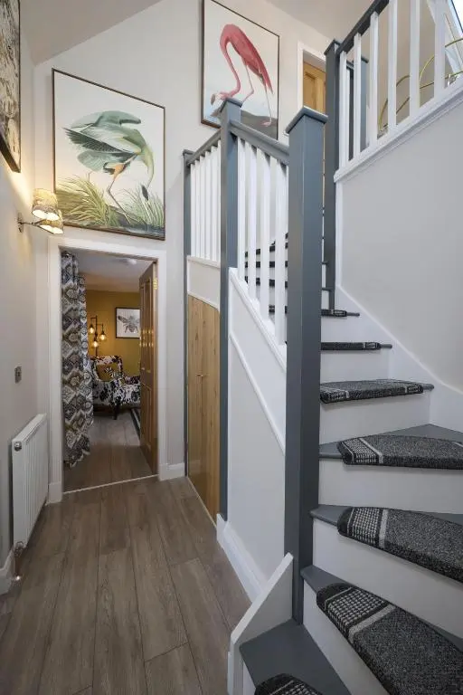 a staircase in a home with a stair case at Balnacraig Farmhouse in Inverness