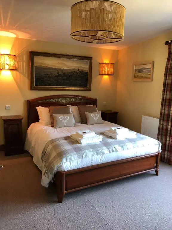 a bedroom with a large bed in a room at The Highland Club in Fort Augustus
