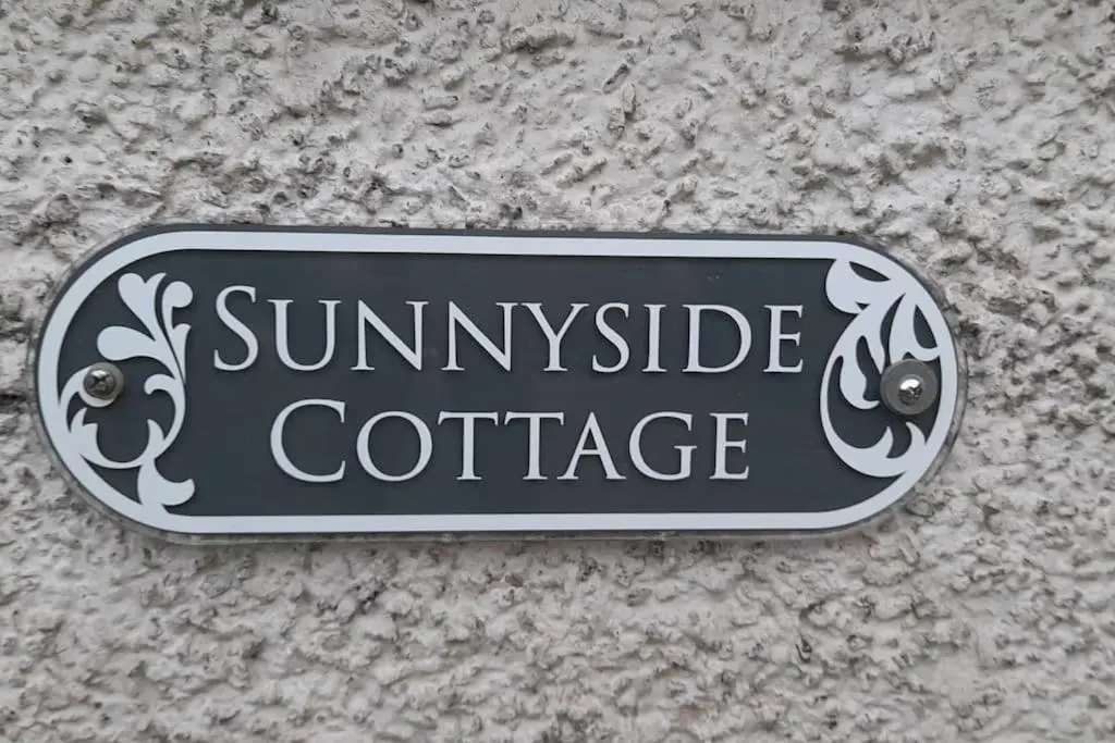 a sign that reads sunriseridge cottage on a wall at Sunnyside Cottage 2 Bedrooms 1 Bathroom 1 WC 2 Pets Welcome in Hilton of Cadboll
