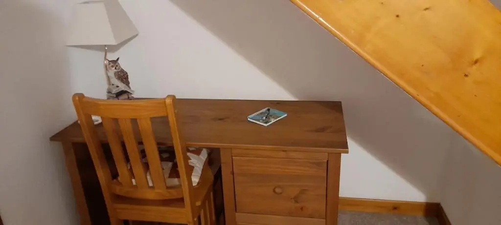 a wooden desk with a chair next to a staircase at Sunnyside Cottage 2 Bedrooms 1 Bathroom 1 WC 2 Pets Welcome in Hilton of Cadboll