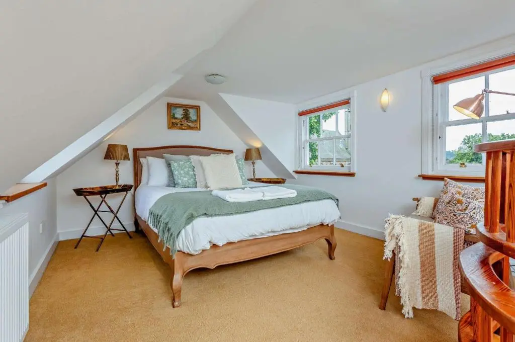 a bedroom with a bed in a attic at Jacobite's Retreat, 17th century cottage in the heart of Inverness in Inverness