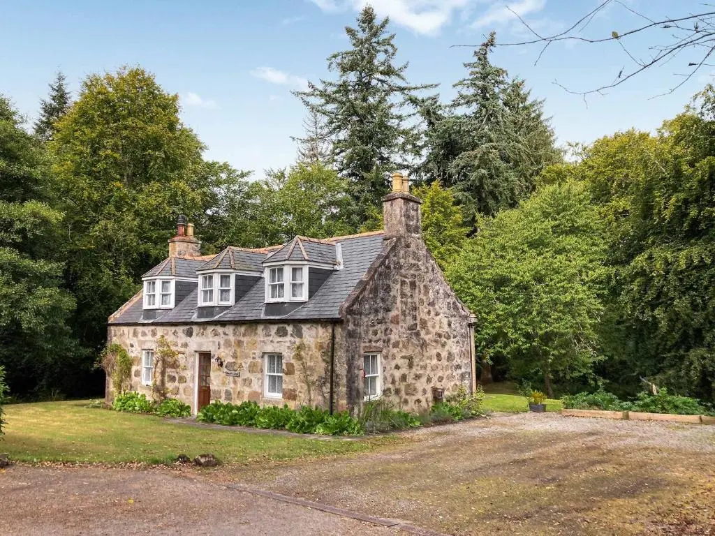 an old stone house in the middle of a field at South Lodge in Banchory