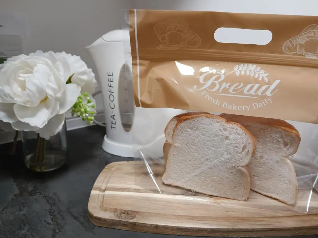 a loaf of bread on a cutting board with a bagel at The Hideaway Inverurie in Inverurie