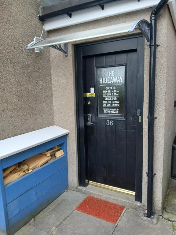 a black door with a sign on it at The Hideaway Inverurie in Inverurie