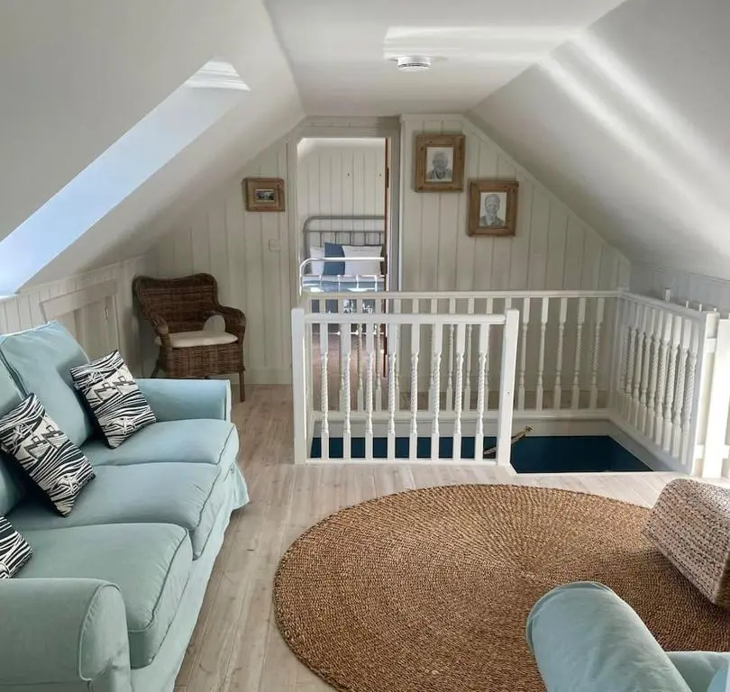 a living room with a couch and a crib at The Millie Luxury Five Star with Sea View in Burghead