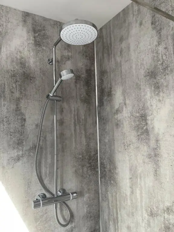 a shower with a shower head in a bathroom at Lochside Loft - Self Catering Apartment for 2 In a great location for Inverness Airport and both Cabot Highlands & Nairn Golf Courses in Inverness