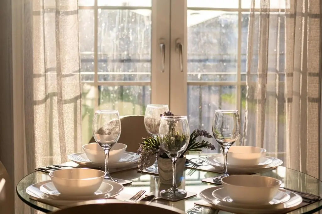 a table with glasses and plates on it with a window at Mackie Residence - SJA Stays - 3 Bed Apartment with parking in Westhill