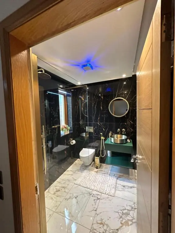 a bathroom with a toilet and a sink at 1 Woodside in Elgin