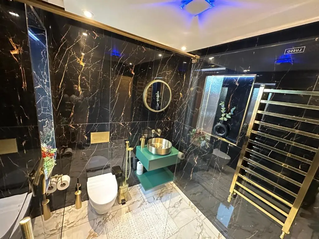 a bathroom with a toilet and a sink at 1 Woodside in Elgin