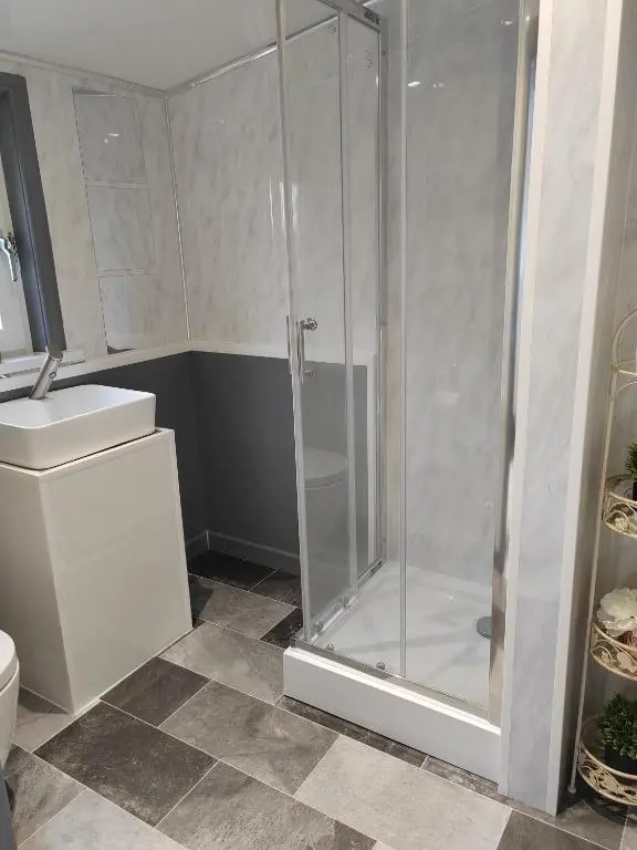 a shower in a bathroom with a toilet and a sink at Westview in Buckie