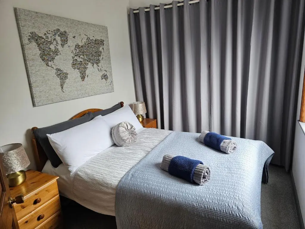 a bedroom with a bed with two pillows on it at Westview in Buckie