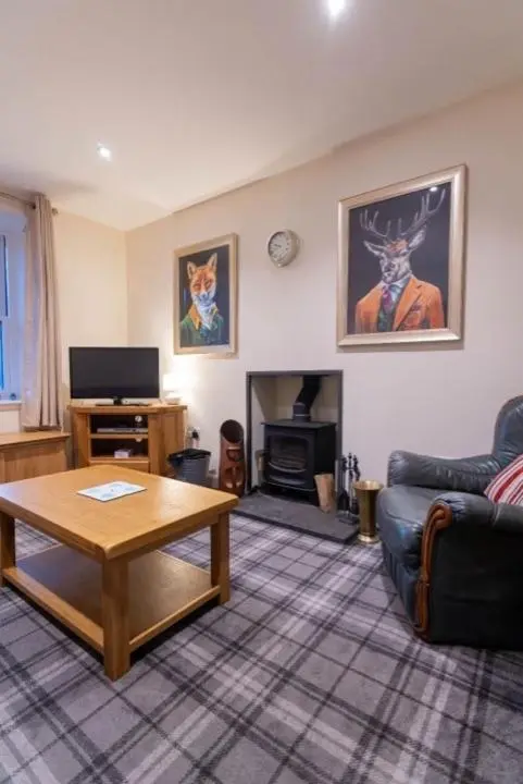 a living room with a couch and a coffee table at 176 Marrell in Helmsdale