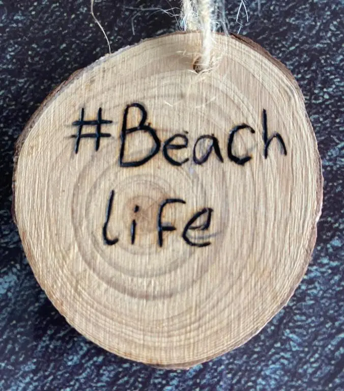 a wooden ornament with the words beach life on it at Beach life in Lossiemouth
