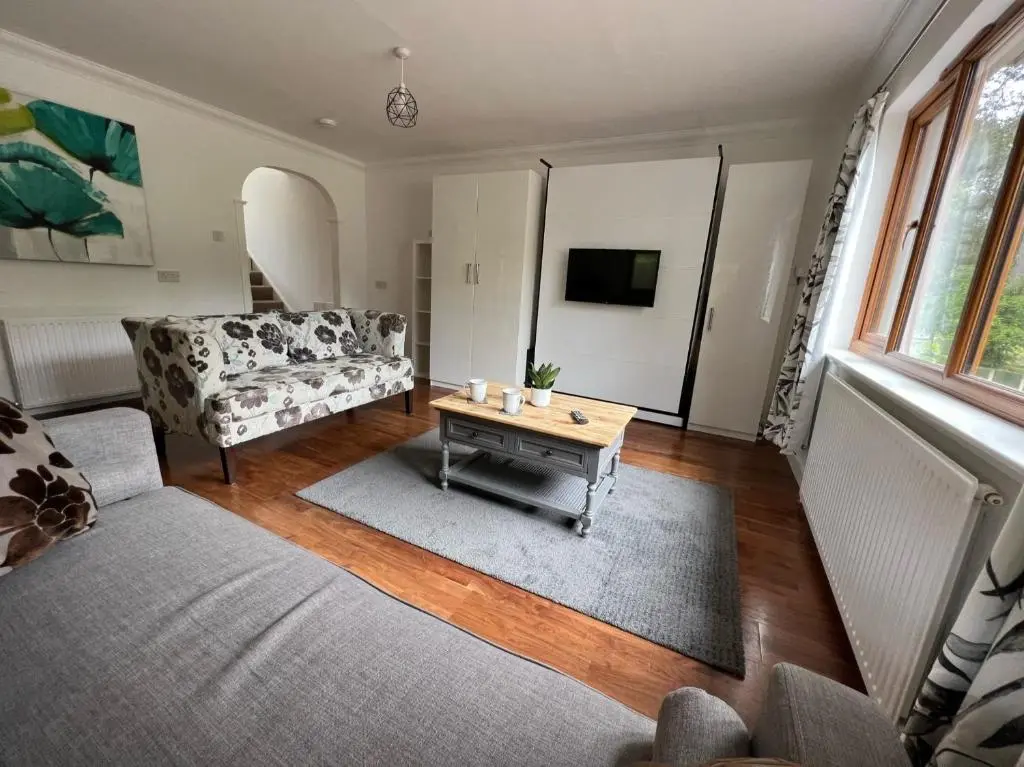 a living room with a couch and a coffee table at Birchwood Cottage in Tore
