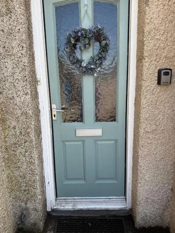 a blue door with a wreath on it at Old Dairy in Tain