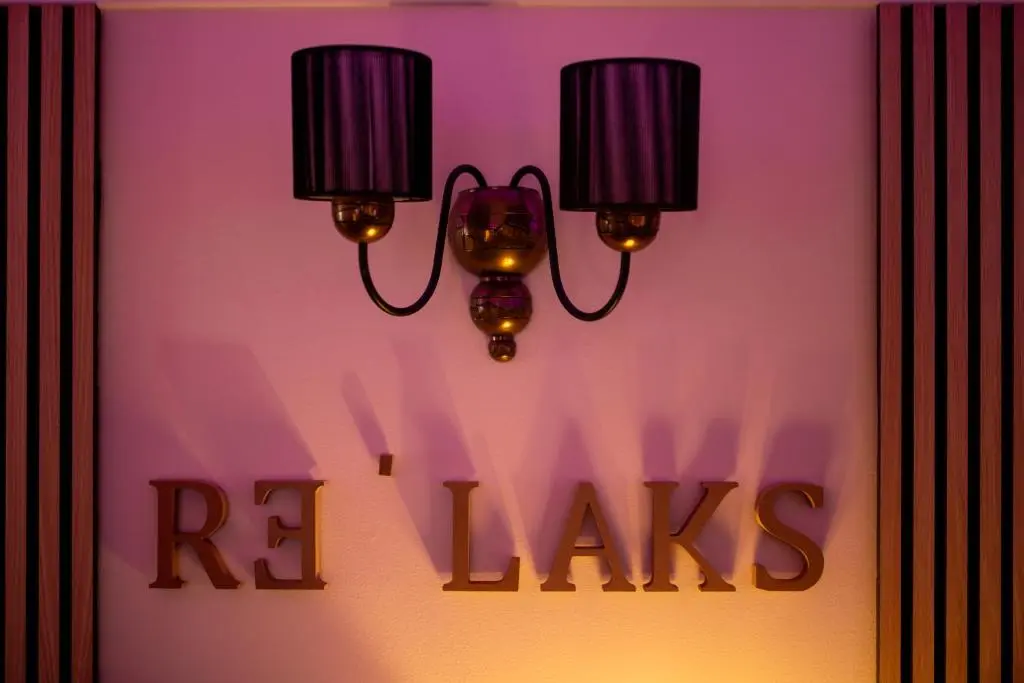 a pair of lights on a wall with the words rxinks at The Koko Rooms in Inverness