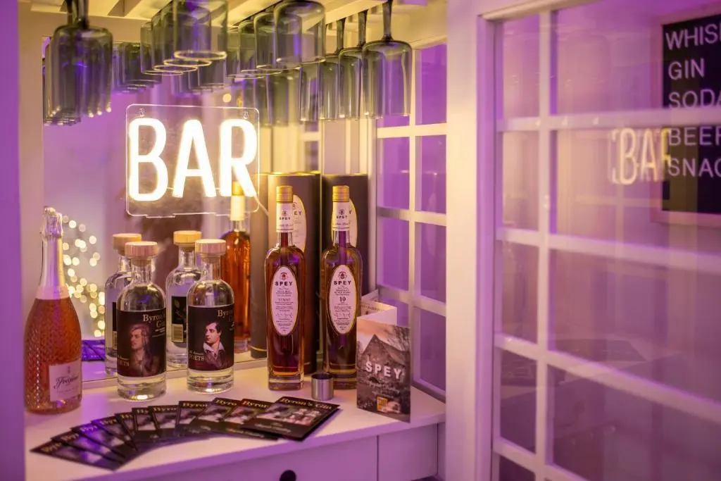 a display of bottles of alcohol on a shelf at The Koko Rooms in Inverness