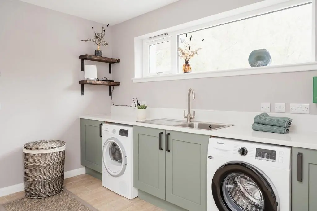 a laundry room with a washing machine and a sink at Culfoichbeg Lodge - Seasgair Lodges in Grantown on Spey