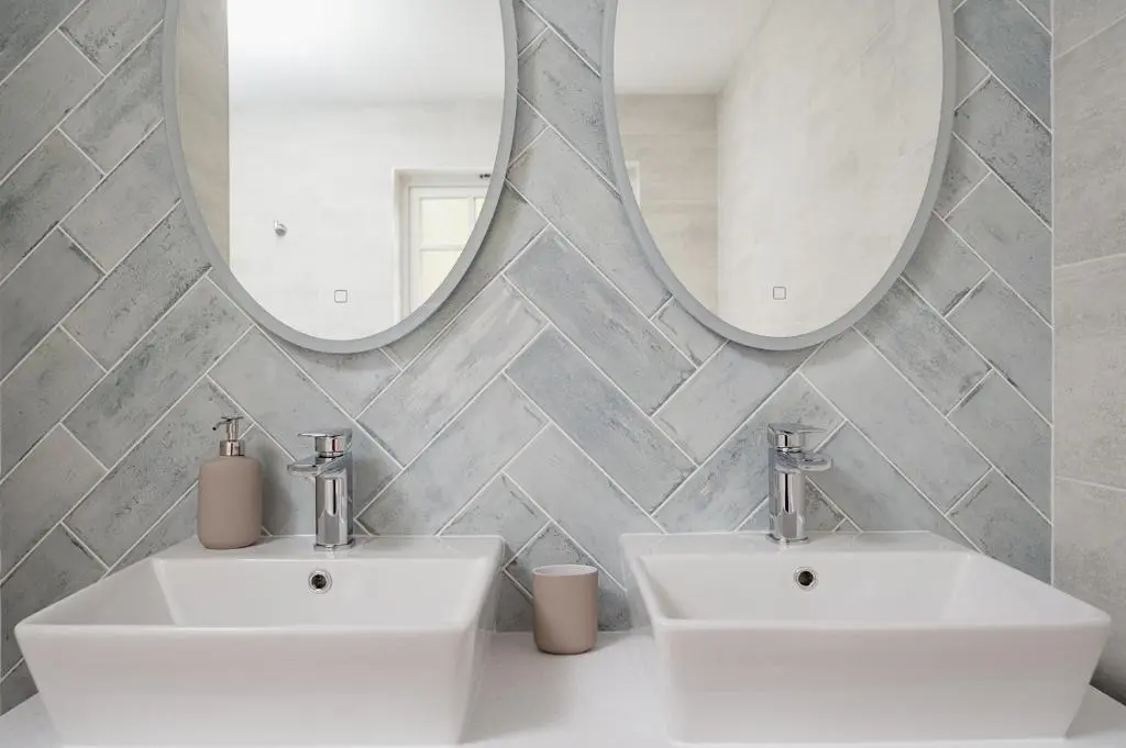 a bathroom with two sinks and a mirror at Culfoichbeg Lodge - Seasgair Lodges in Grantown on Spey