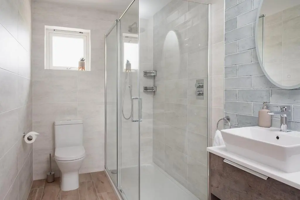 a bathroom with a shower and a toilet and a sink at Culfoichbeg Lodge - Seasgair Lodges in Grantown on Spey