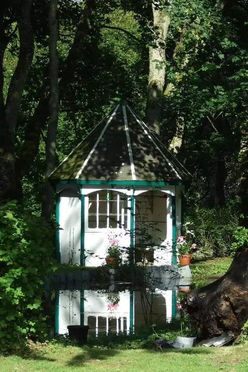 a small white gazebo in the middle of a yard at Thrumster House in Wick