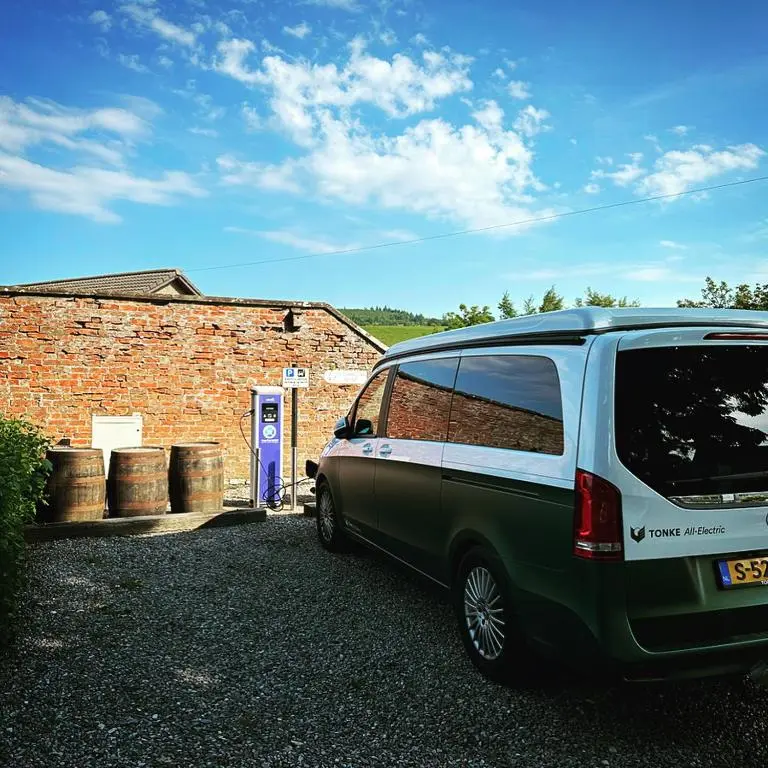 a green and white van parked in front of a brick building at The Malt Van - Beautiful, luxury static caravan in Aberlour