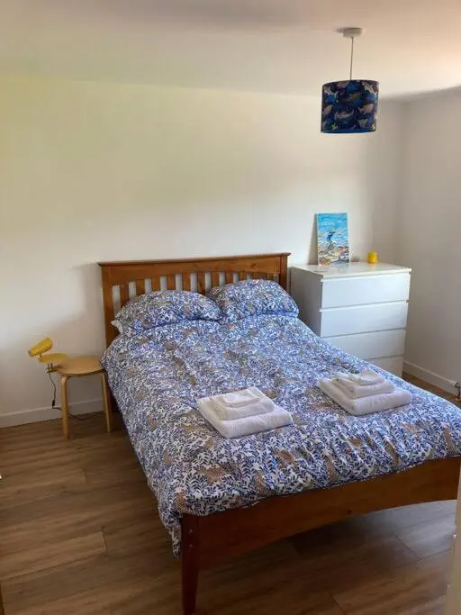 a bedroom with a bed with two towels on it at 3-Bedroom Eco-house with EV charger. in Rosemarkie