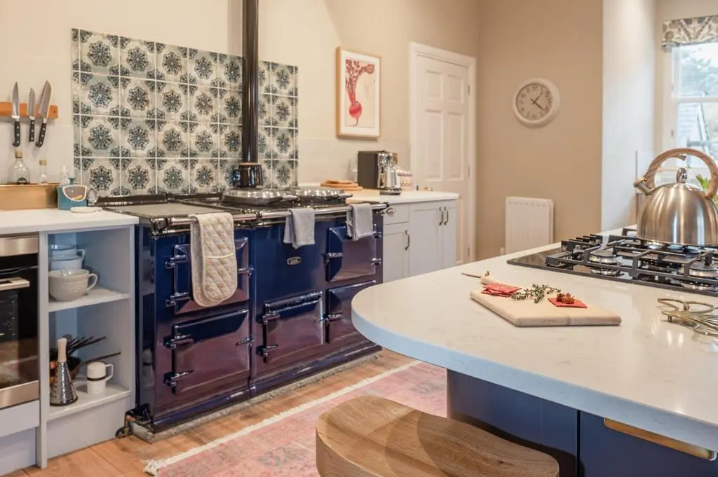 a kitchen with a blue stove and a counter at Milton Lodge - Seasgair Lodges in Newtonmore