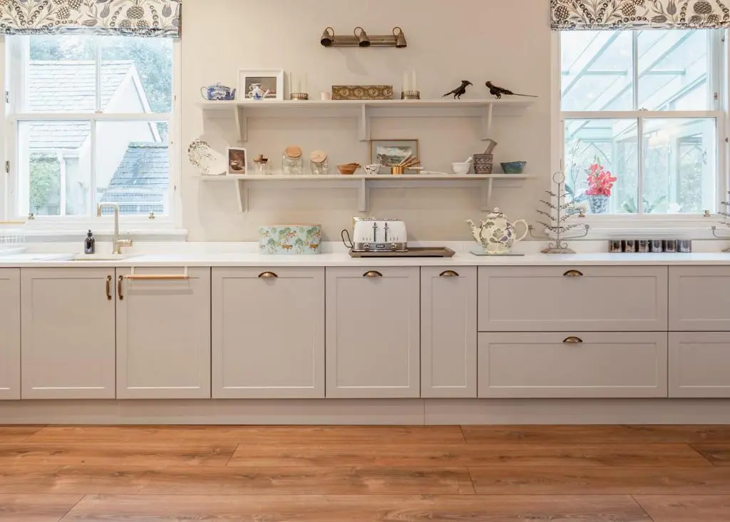 a kitchen with white cabinets and a sink at Milton Lodge - Seasgair Lodges in Newtonmore