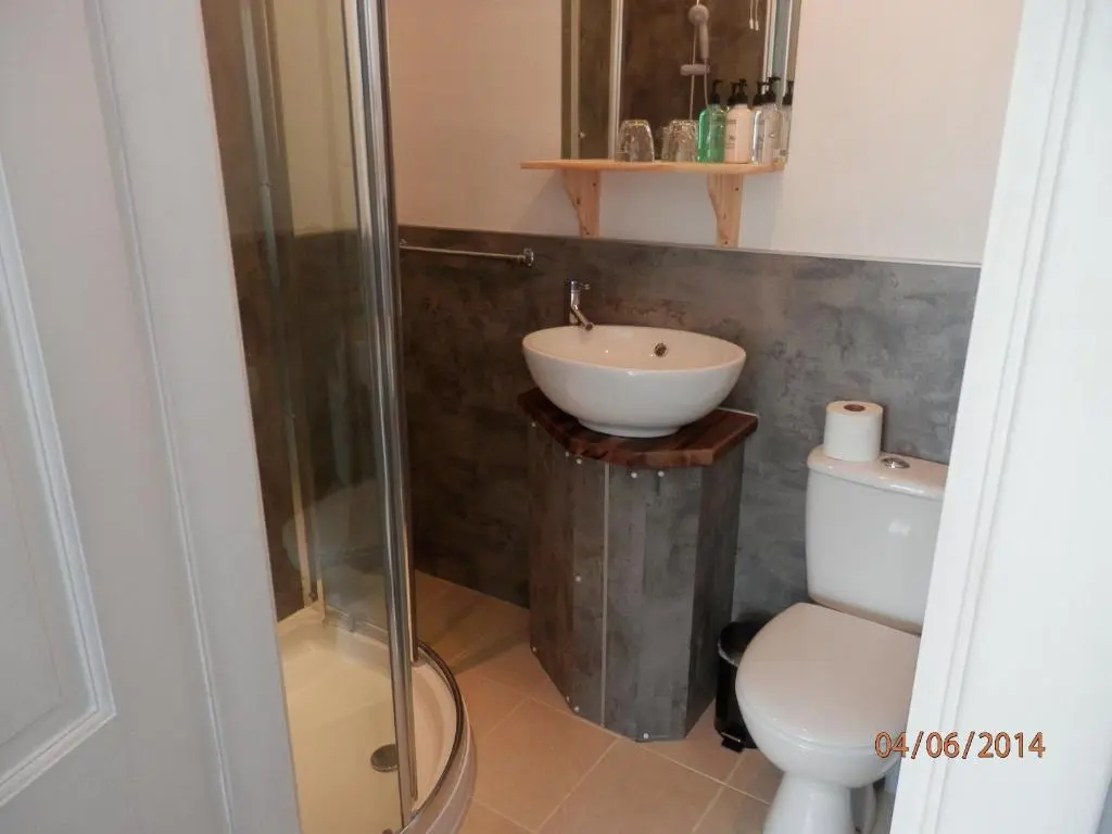 a bathroom with a sink and a toilet at The Whitehouse in Dingwall