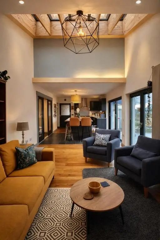 a living room with couches and a table at The Highland MoonRay in Inverness