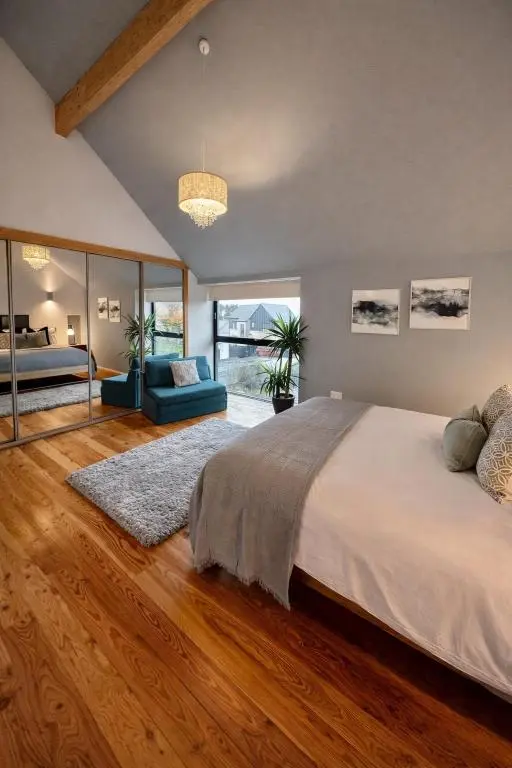 a bedroom with a large bed and a large window at The Highland MoonRay in Inverness