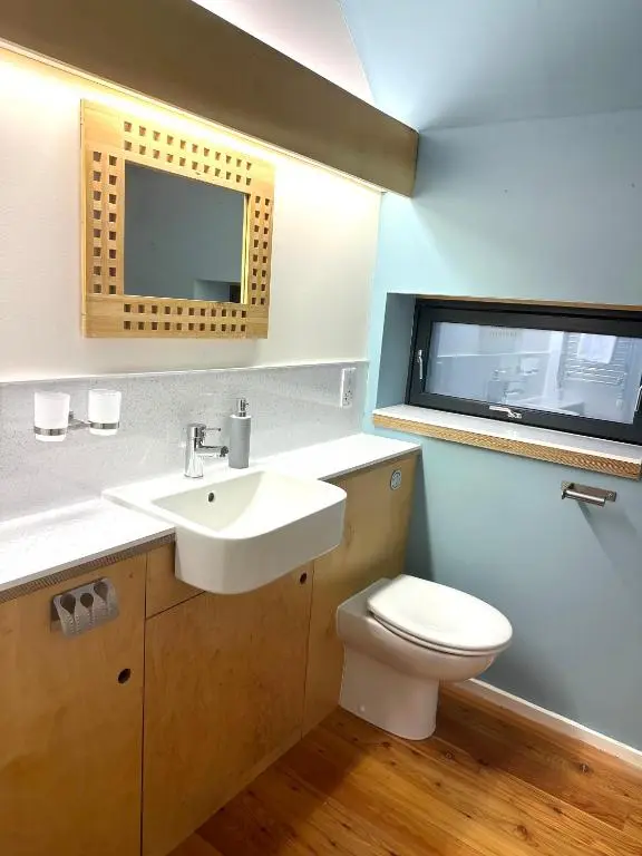 a bathroom with a white sink and a toilet at The Highland MoonRay in Inverness