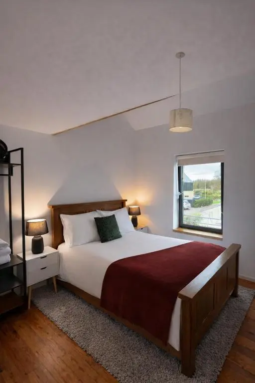 a bedroom with a large bed and a window at The Highland MoonRay in Inverness
