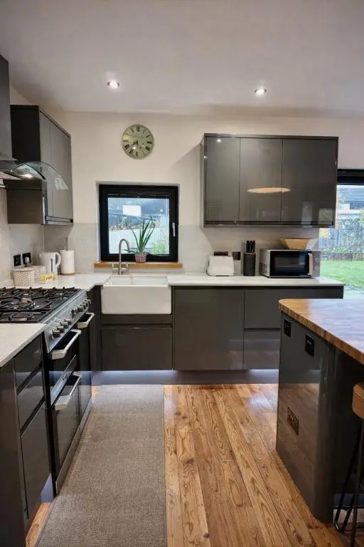 a kitchen with stainless steel appliances and a window at The Highland MoonRay in Inverness