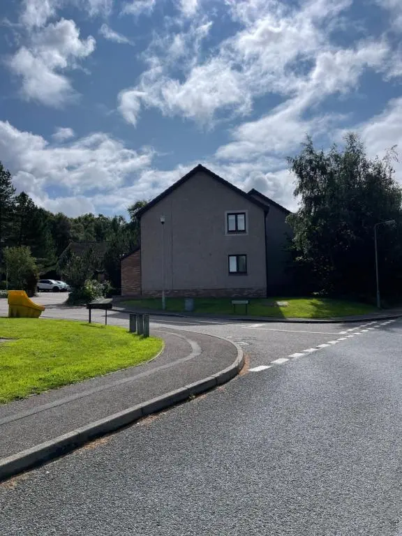 a house on the side of a road at Comfortable, modern apartment with parking. Inverness. in Inverness