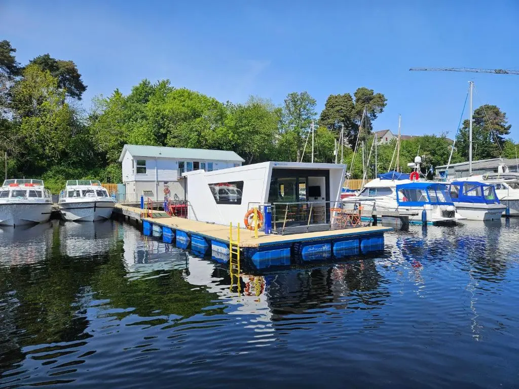 a small boat is docked at a dock in the water at Caley Cruisers in Inverness