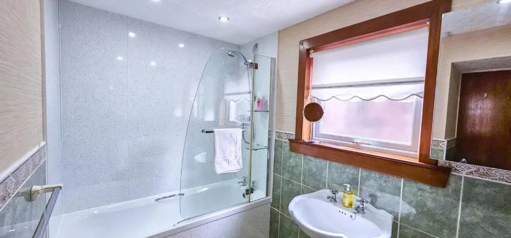 a bathroom with a sink and a shower at mySTAYINN Abermar 12 Bedroom House in Inverness
