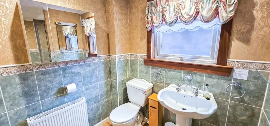 a bathroom with a toilet and a sink at mySTAYINN Abermar 12 Bedroom House in Inverness