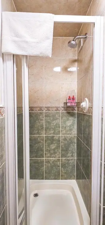 a bathroom with a shower and a bath tub at mySTAYINN Abermar Guest House in Inverness