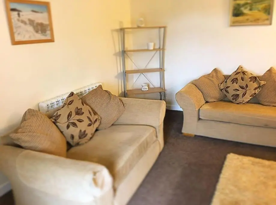 a living room with a couch and two couches at Traditional Croft Cottage Minutes from Lochness in Drumnadrochit