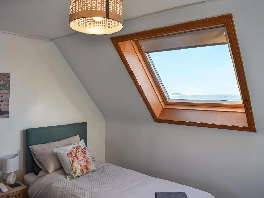 a bedroom with a window and a bed in it at Strathlene Lodge in Ianstown