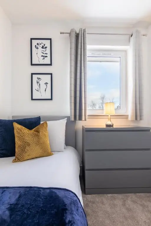 a bedroom with a bed and a window at Fletcher's Gate in Inverness
