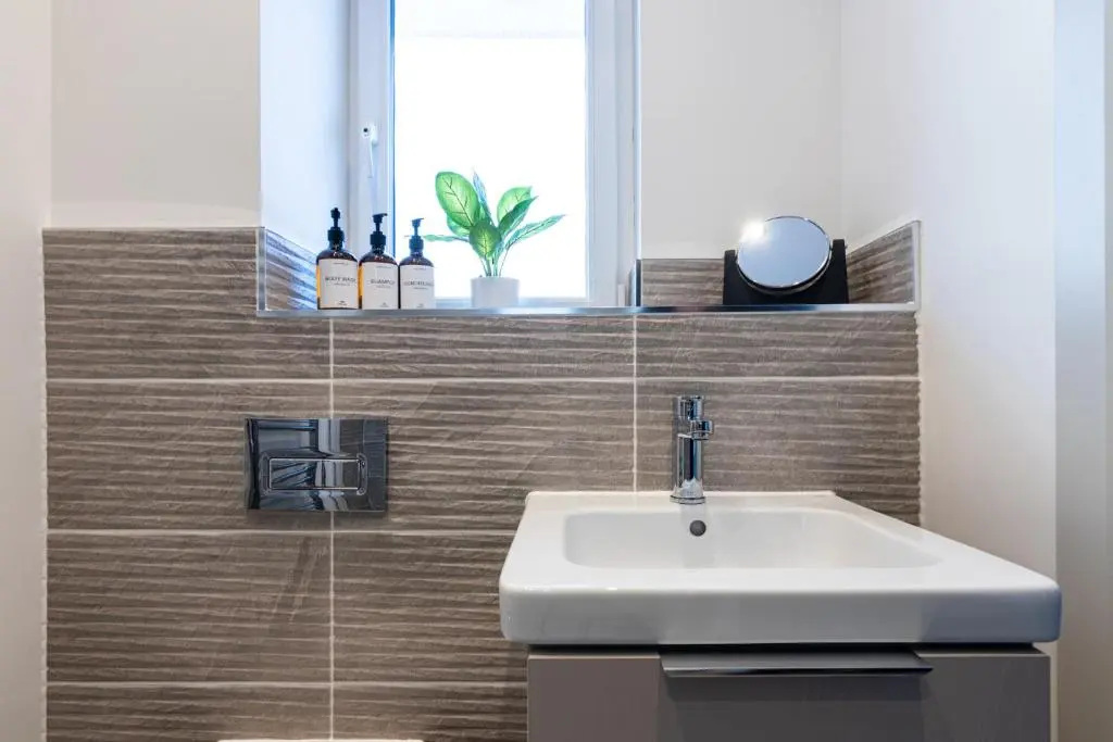 a bathroom with a sink and a mirror at Fletcher's Gate in Inverness