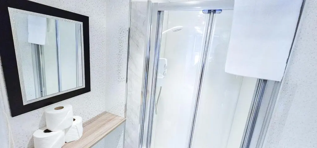 a bathroom with a shower and a mirror at mySTAYINN Kinloch 7 Bedroom House in Inverness