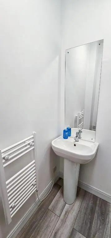 a white bathroom with a sink and a mirror at mySTAYINN Melrose Villa in Inverness