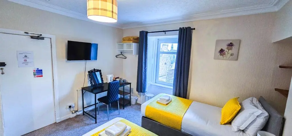 a small room with a bed and a window at mySTAYINN Telford Guest House in Inverness