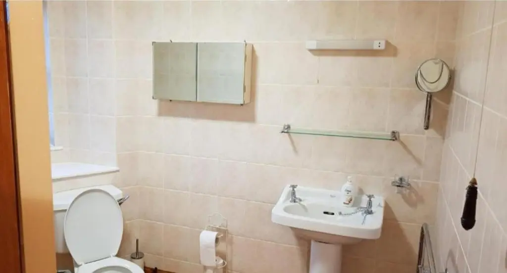a bathroom with a toilet and a sink at Ness City Apartment in Inverness
