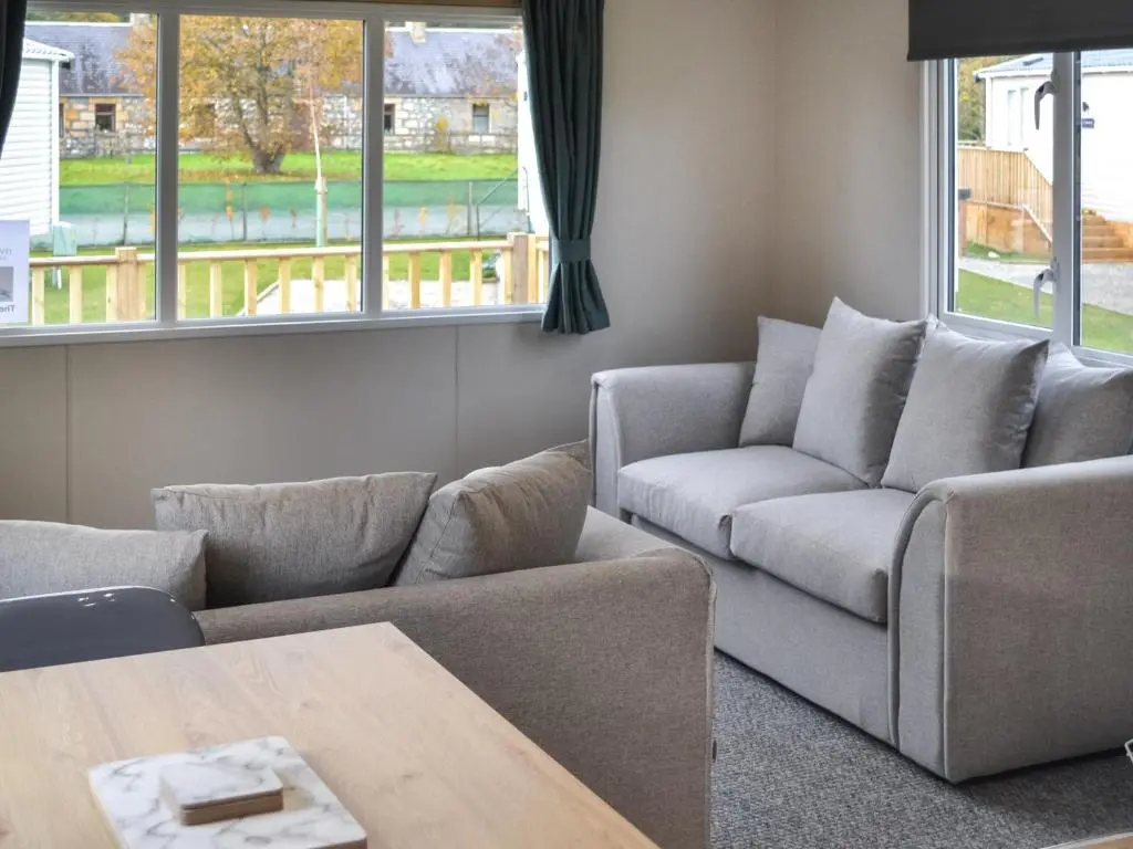 a living room with two couches and a table at The Falcon - Uk45538 in Dyke
