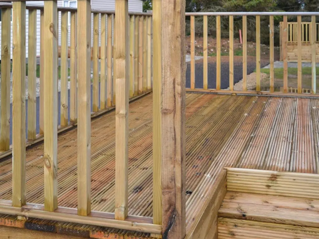 a wooden deck with a fence on it at The Falcon - Uk45538 in Dyke